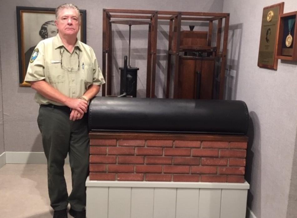 Park Ranger Tom Fugate standing next to the ice machine in Dr. John Gorrie State Park.