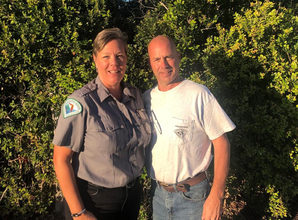 Tom and Michele Bill stand at Long Key State Park in front of native vegetation