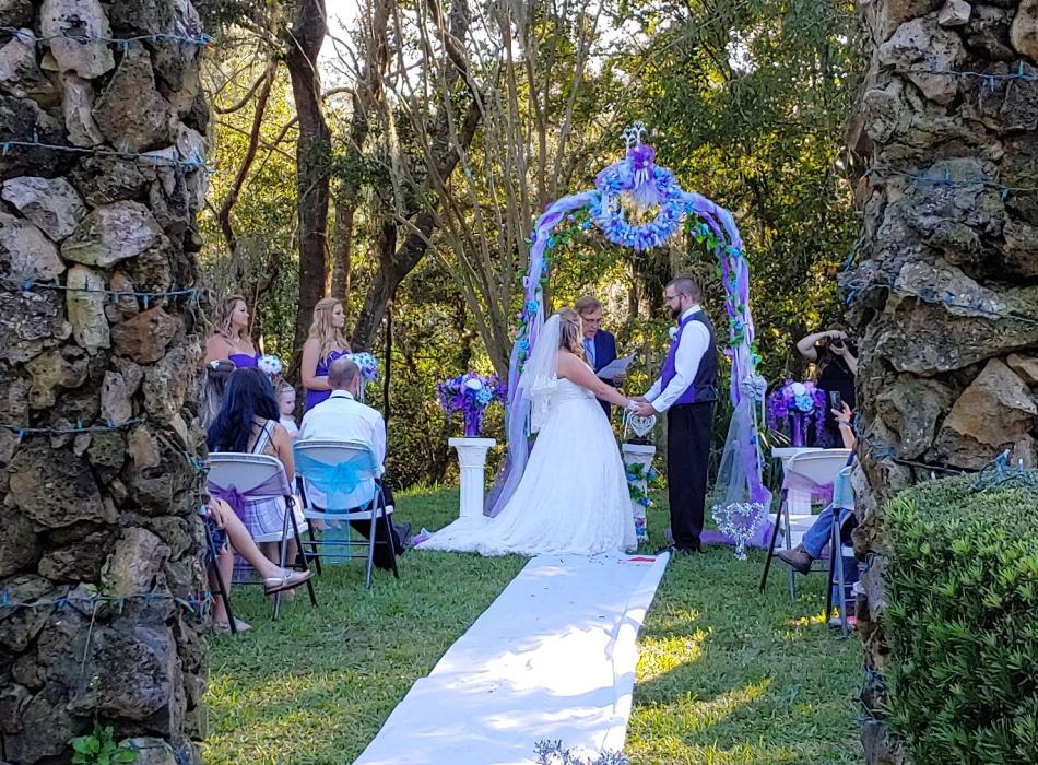 Wedding between two stone columns under an arch. 
