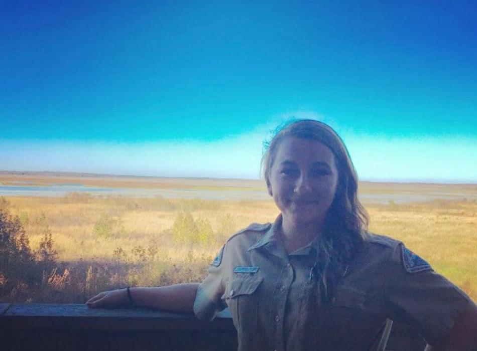 Image of Ashley Crawford, park ranger at Paynes Prairie preserve state park with the extensive prairie in the background.