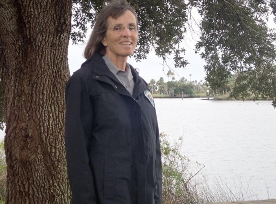 Image of volunteer Buffy De Matteis standing next to a tree.