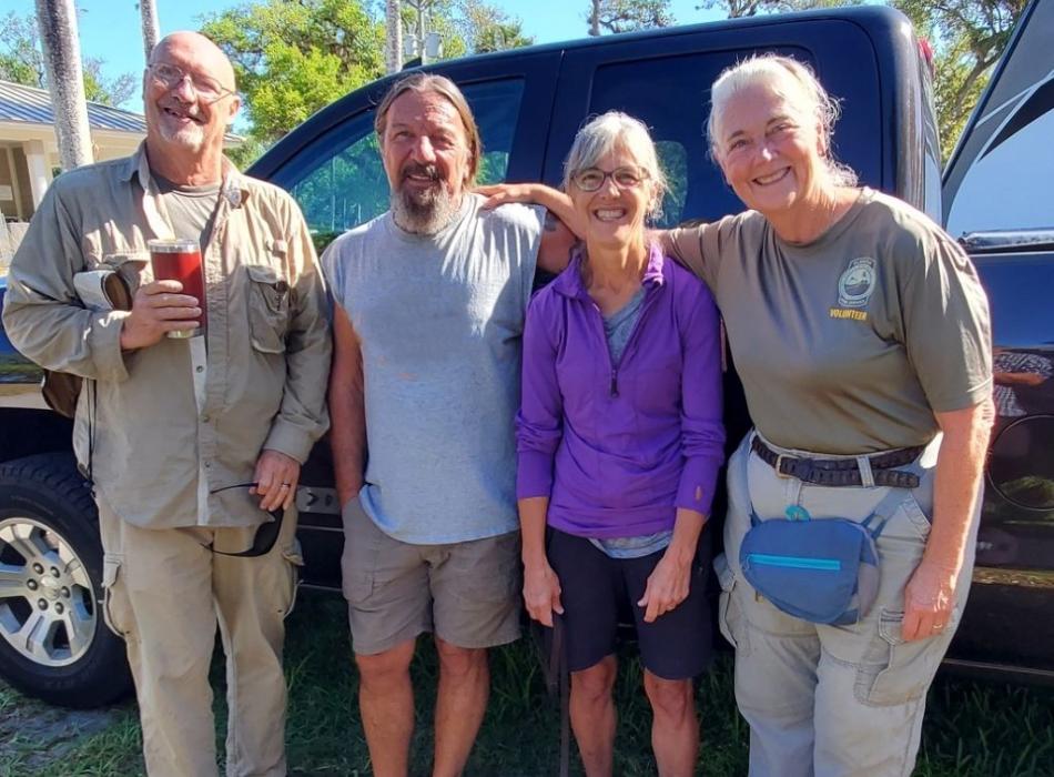 four people standing 